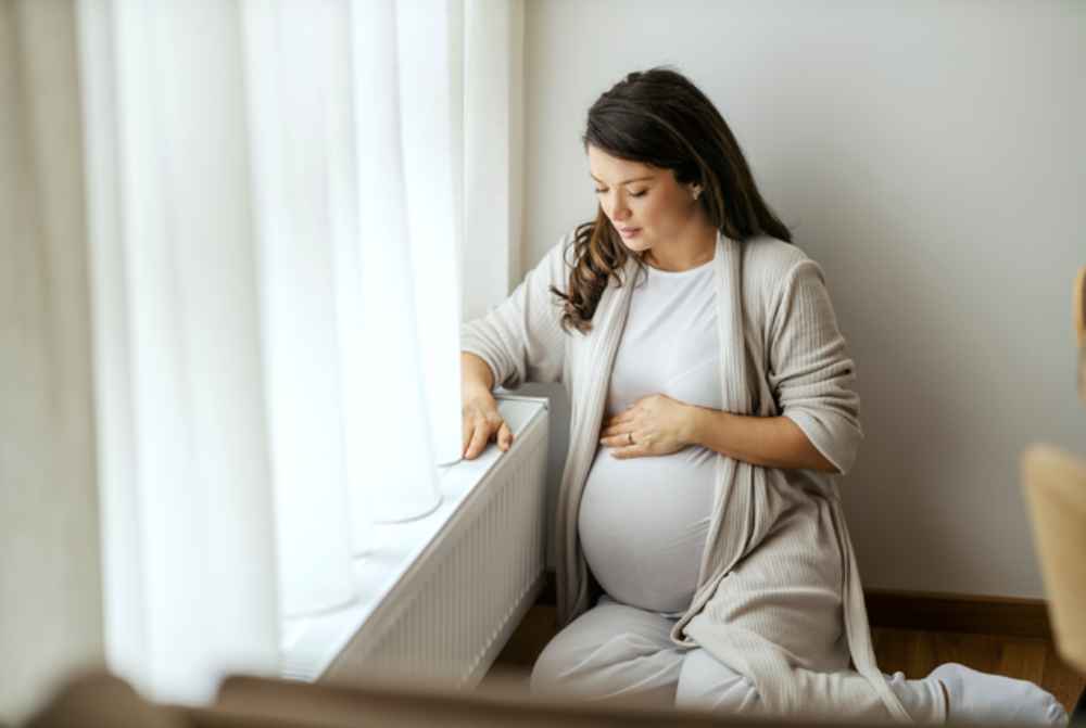 Expectant mother dealing with piles during pregnancy, learning about safe treatments